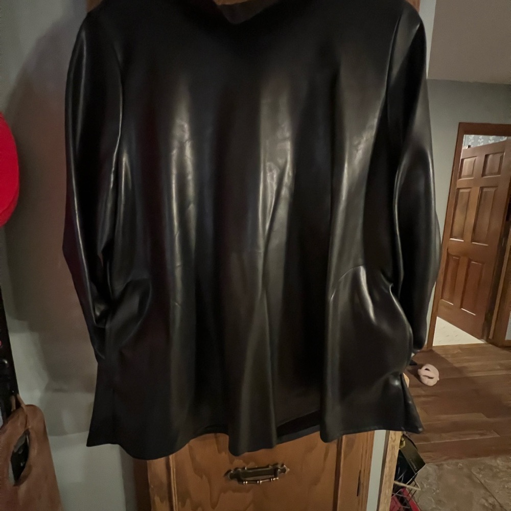 Soft, black leather blouse. High collar with low set leather bow on the back.